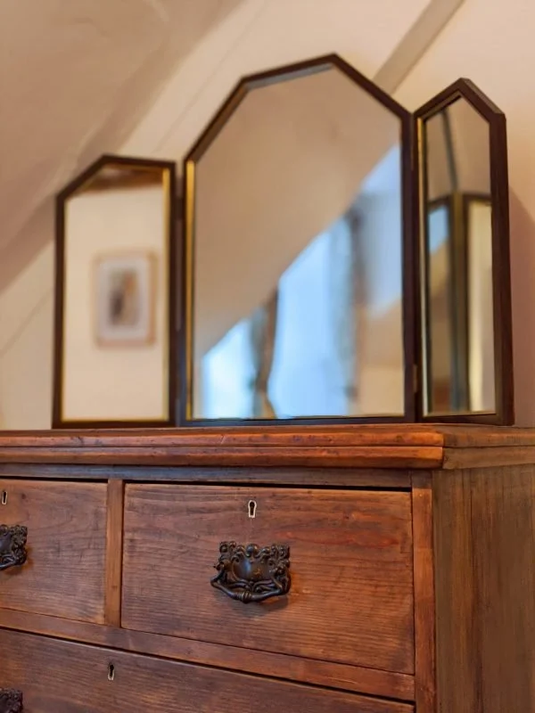 Picture of old fashioned bedroom furniture with triptych mirror