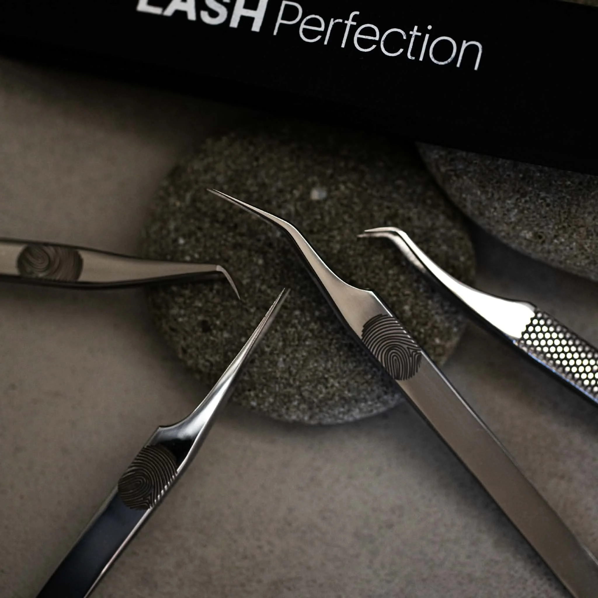 Professional lash tweezers, adhesive and eyelash extension trays used for beginner lash training