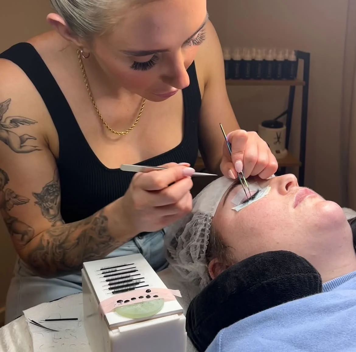 Beginner lash student practising professional eyelash extension techniques on a model
