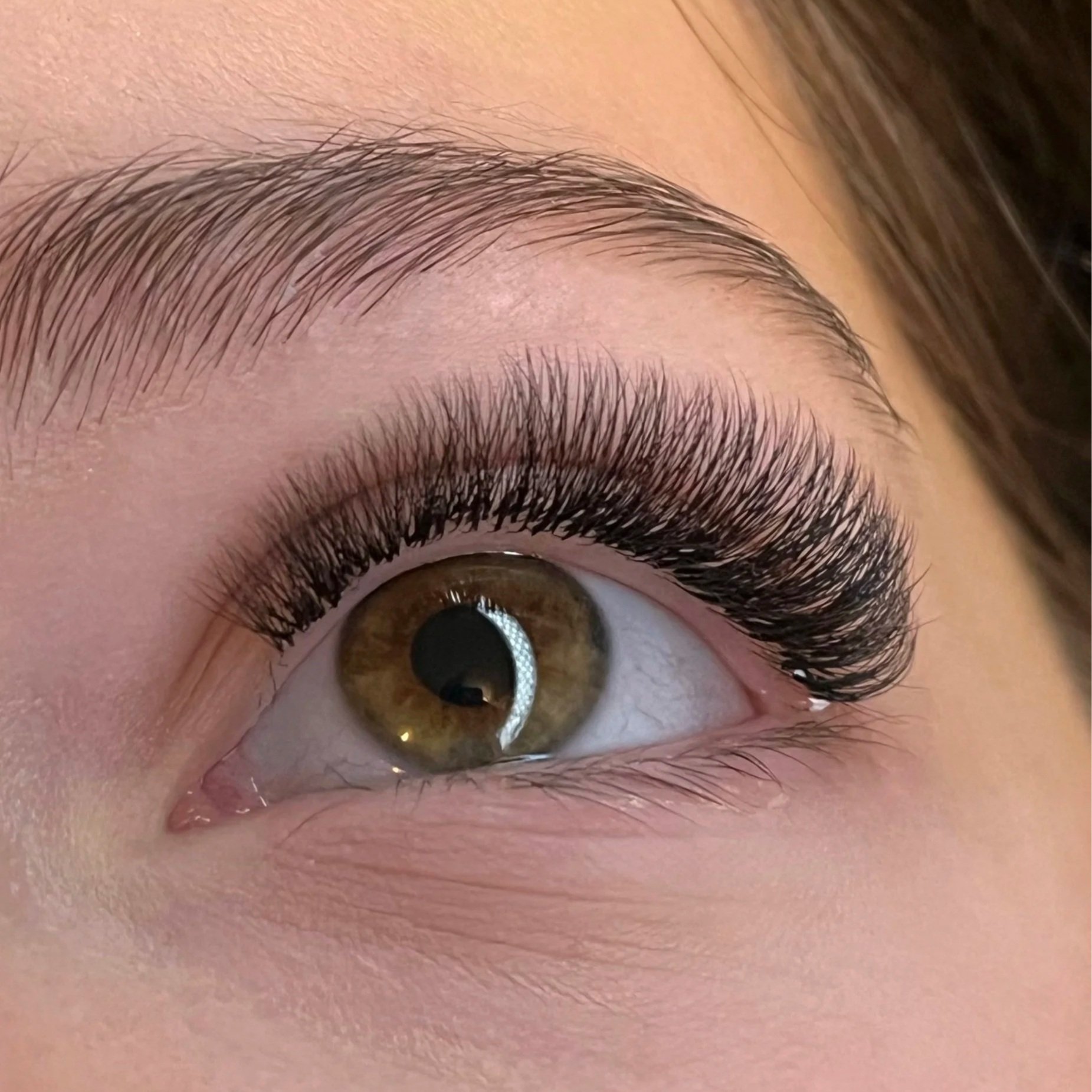 Professional eyelash extension set showing clean placement, isolation and consistent lash direction