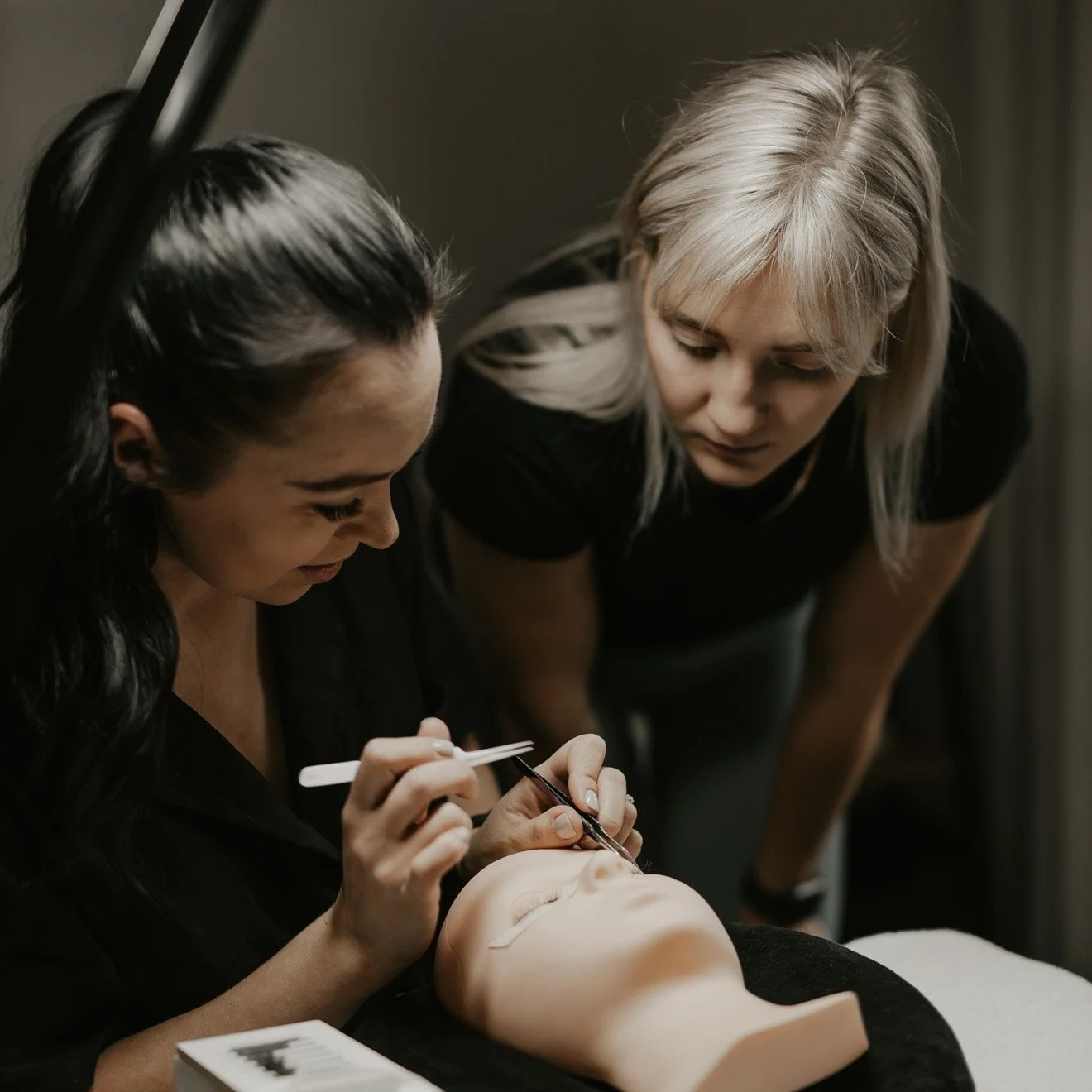 Olga Fleming providing in-person eyelash extension training to a lash student in Christchurch