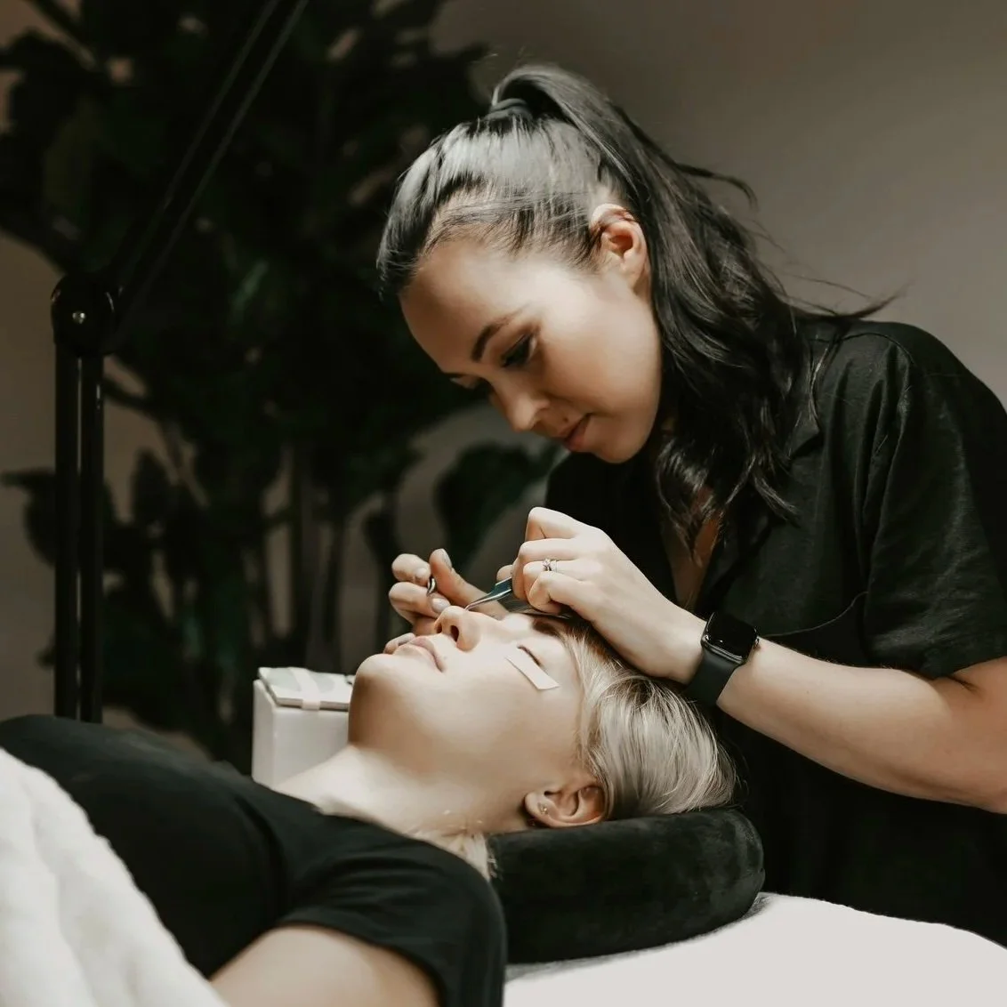 Olga Fleming applying eyelash extensions to a client in her Christchurch lash studio