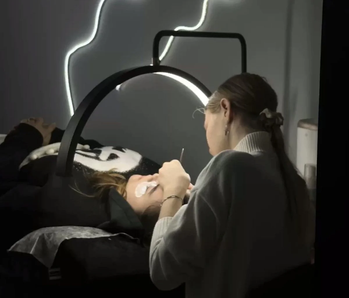 Beginner lash student practising eyelash extension application during professional lash training