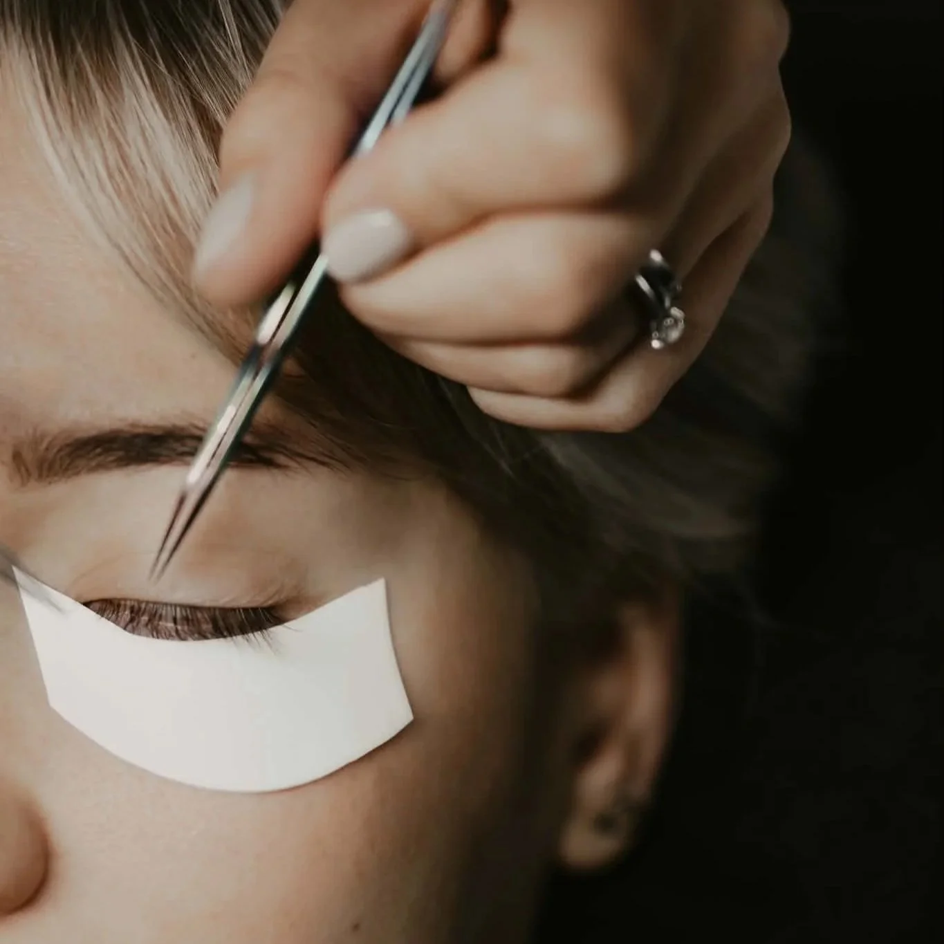 Beginner lash student practising isolation technique during professional eyelash extension training