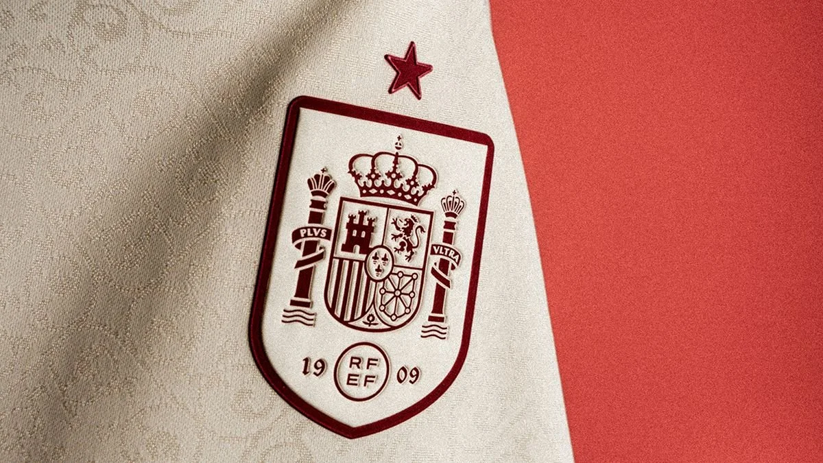 Spanish national football team crest or badge on fabric, featuring a shield with a crown, lions, castles, and the year 2009, with red, white, and maroon colors.