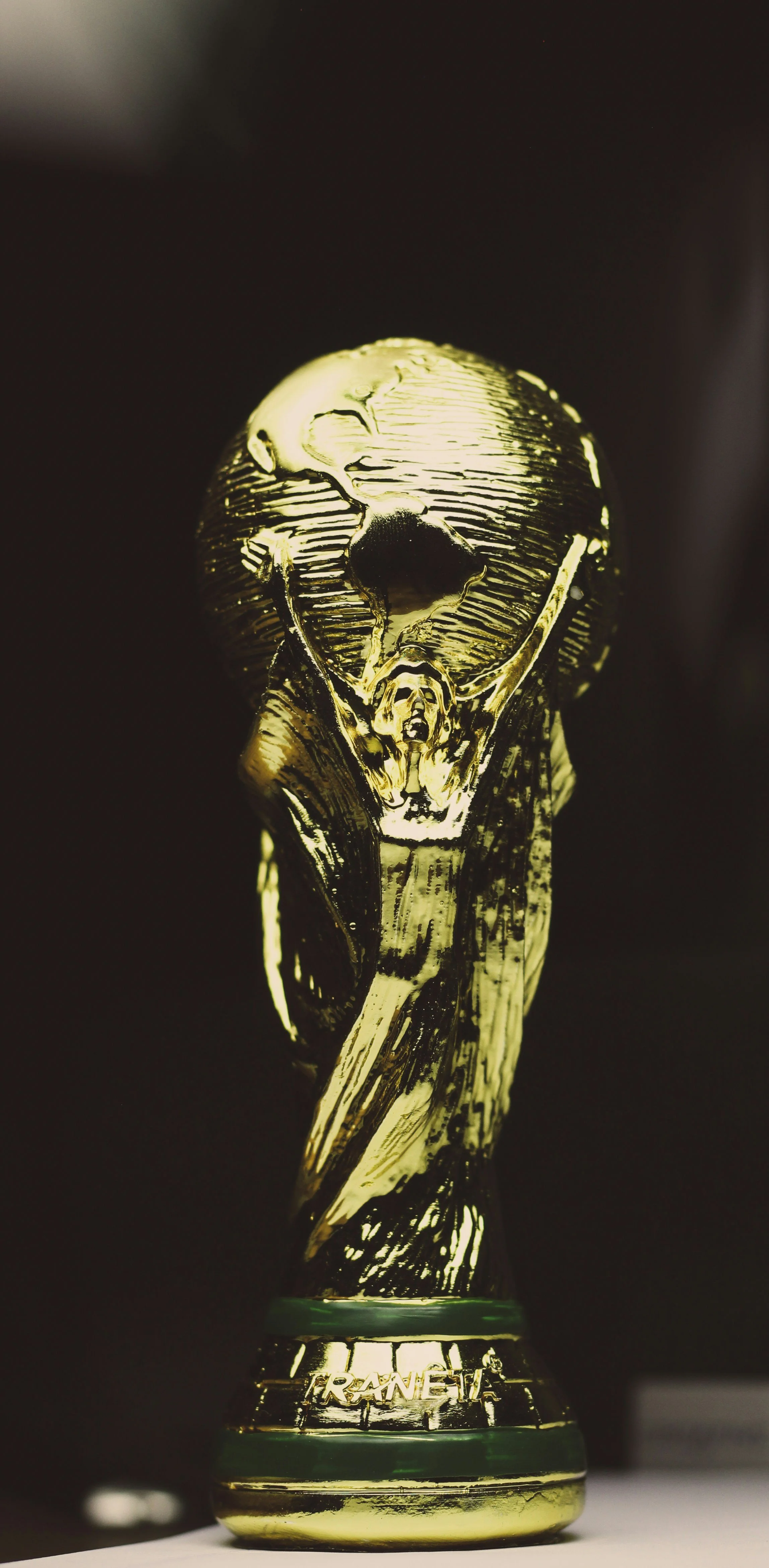A golden trophy with a design resembling a sci-fi spaceship or alien flying saucer, with a figure in front of it with arms raised, and the word 'TRANCE' written on the base.