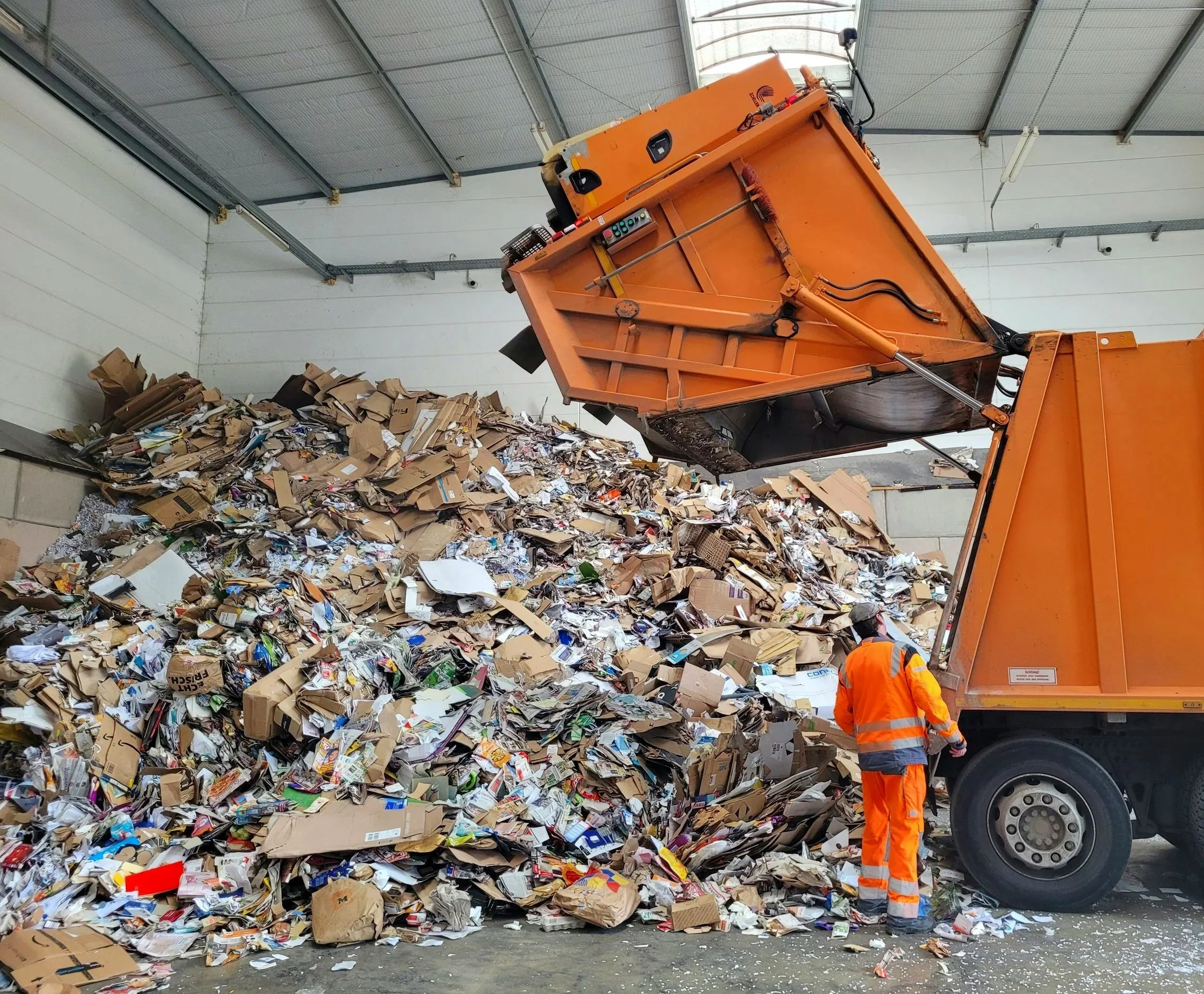 Truck depositing large amount of household waste at sorting facility