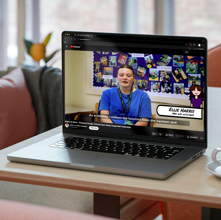 An image of a laptop on a table showing on the screen one of the videos of an intern who had completed the programme and found full time work