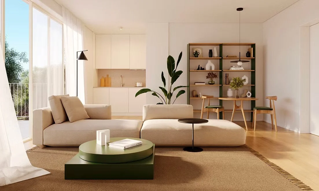 Bright living room with beige sofa, green coffee table, large window with sheer curtains, bookshelf with decorative items, dining table with four chairs, and potted plant.