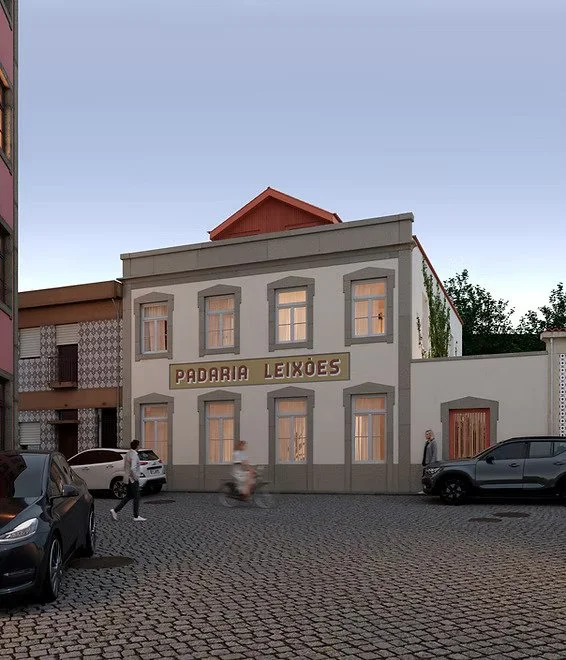 A two-story bakery shop named 'Padaria Leixões' with a white facade and gray accents, located on a cobblestone street. Several cars are parked in front, and a few people are walking nearby. The sky is clear.