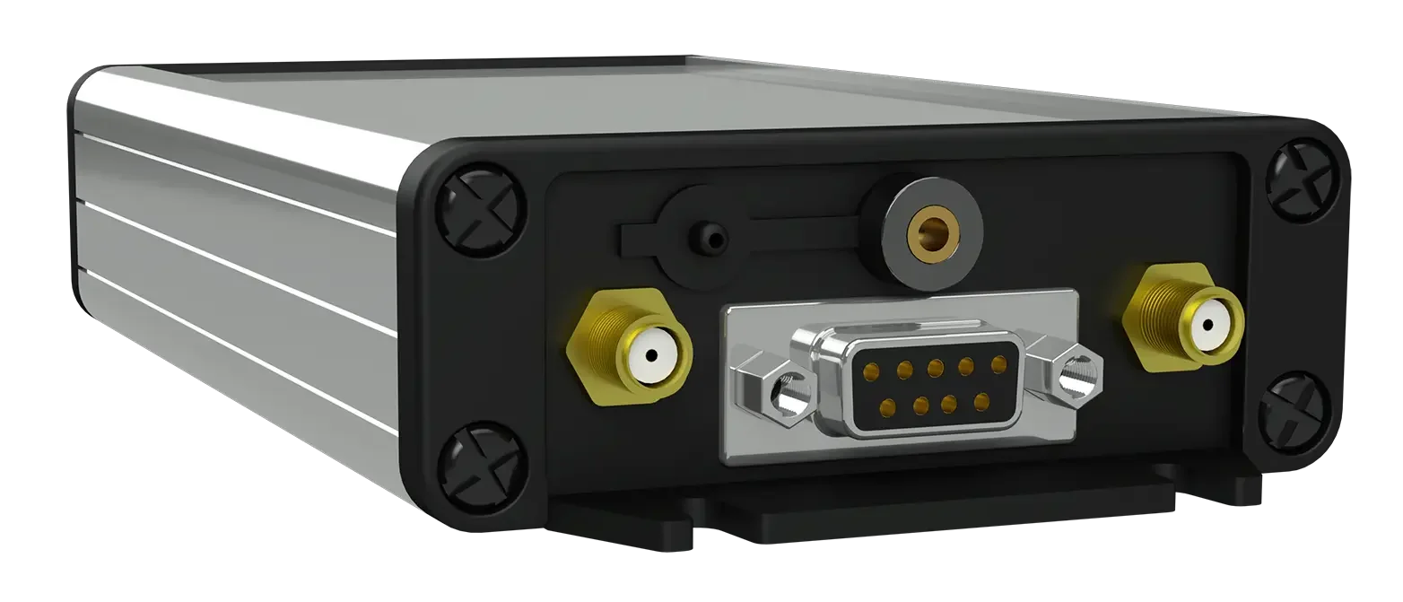 An industrial device with a metallic rectangular body, black front panel, and multiple connectors including a DB9 port, yellow and white coaxial connectors, and other small ports.
