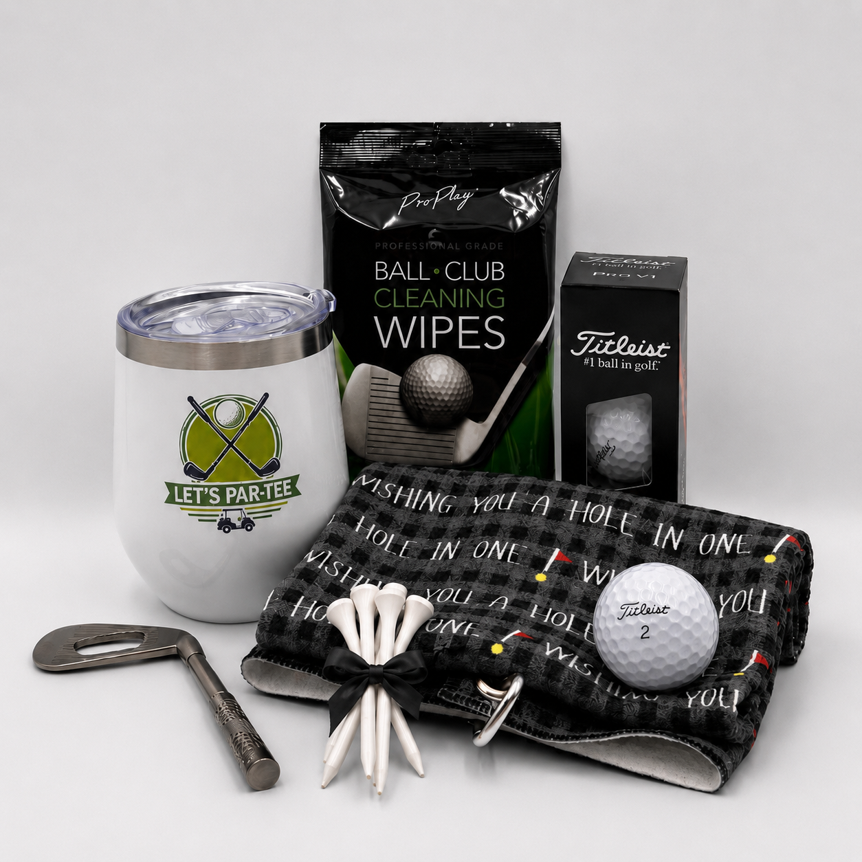 The Signature 19th Hole golf gift box with a ceramic tumbler, golf balls, tees, snacks, and golfer accessories