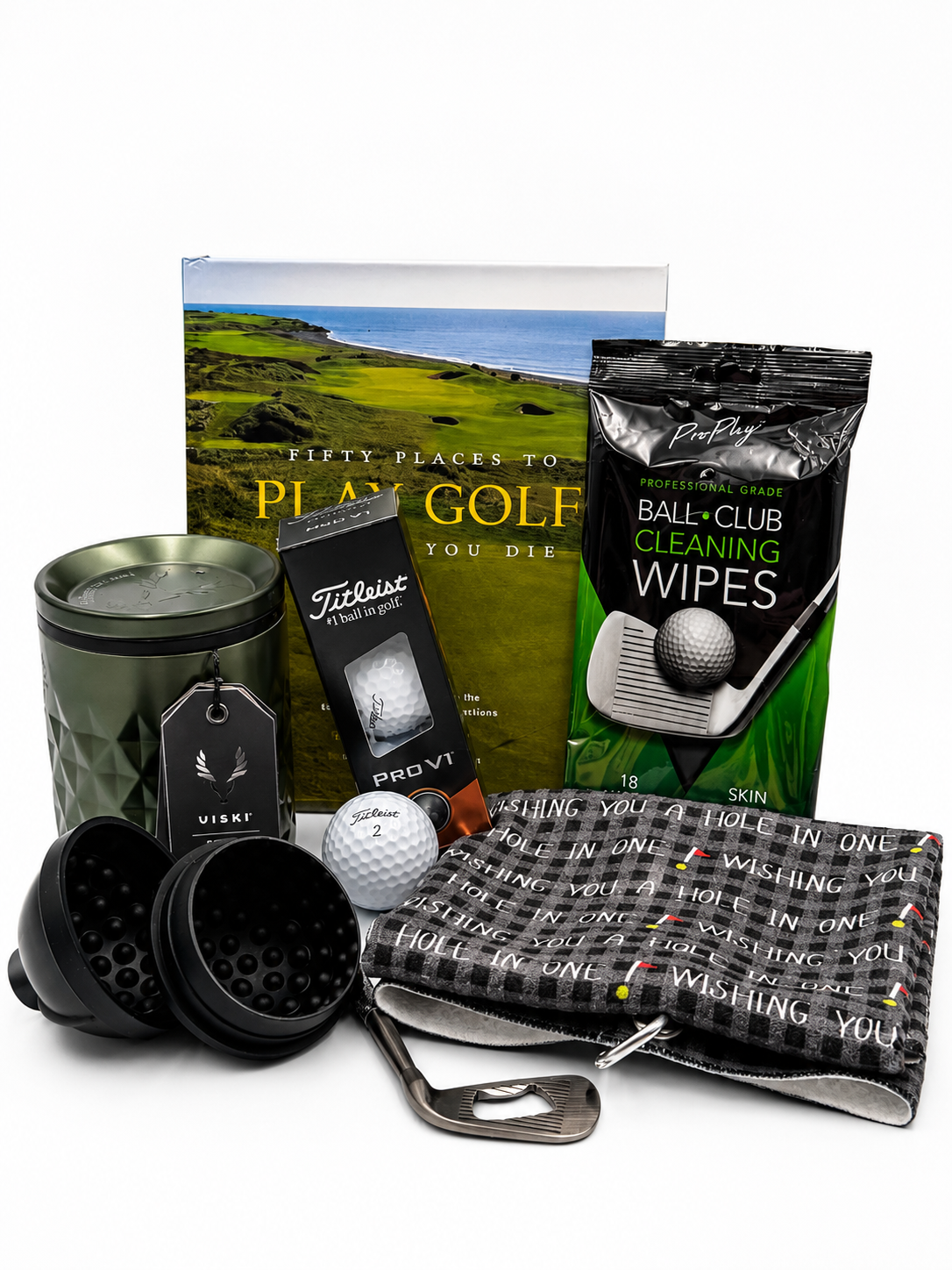A collection of golf accessories including golf balls, golf tees, a golf towel, a golf club cleaner wipes, a golf ball marker, and a container, with a golf-themed book in the background.