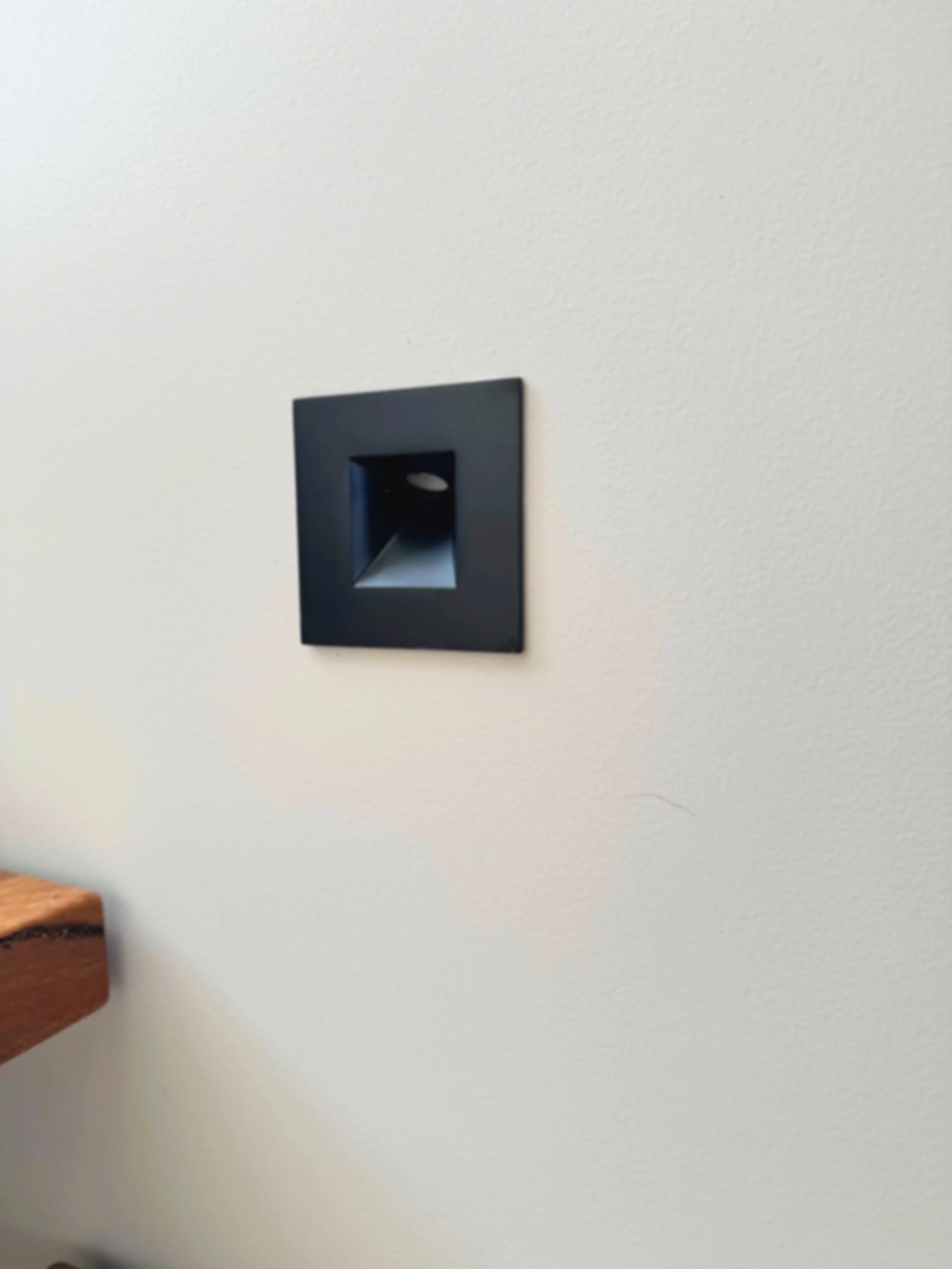 STAIRWAY LIGHTING - A sleek black wall light designed to illuminate the stairs with style, safety, and a modern architectural finish.