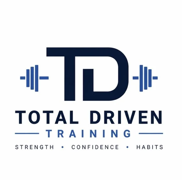 Logo for Total Driven Training featuring a large 'T D' with barbell icons on either side, and the words 'Total Driven Training' with the tagline 'Strength, Confidence, Habits'.