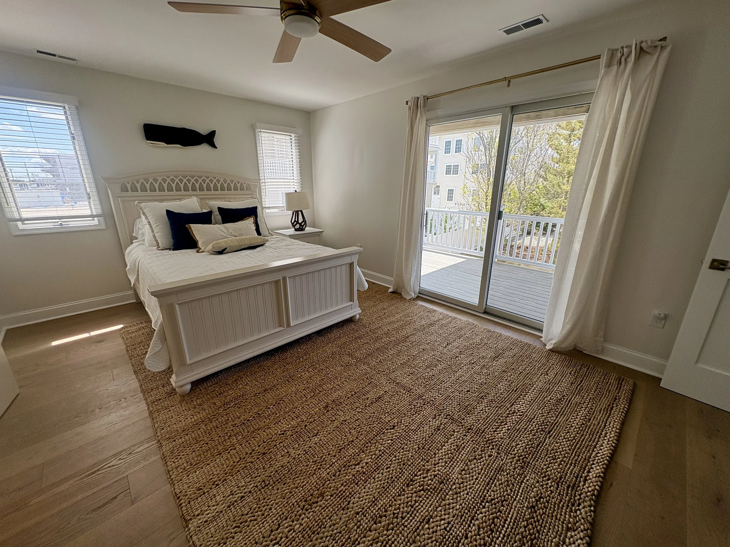 2nd bedroom with a queen bed, private rear-facing deck with seating area and direct access to the 1st floor full bathroom