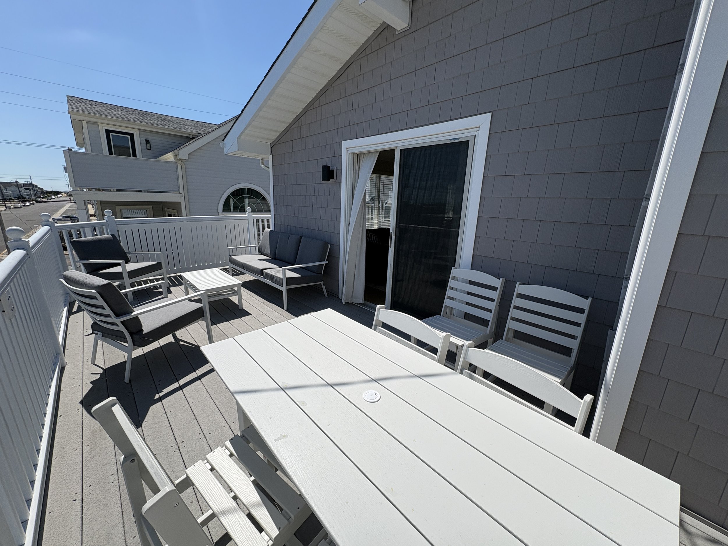 Private deck off living room with comfortable lounge area and seperate dining table.