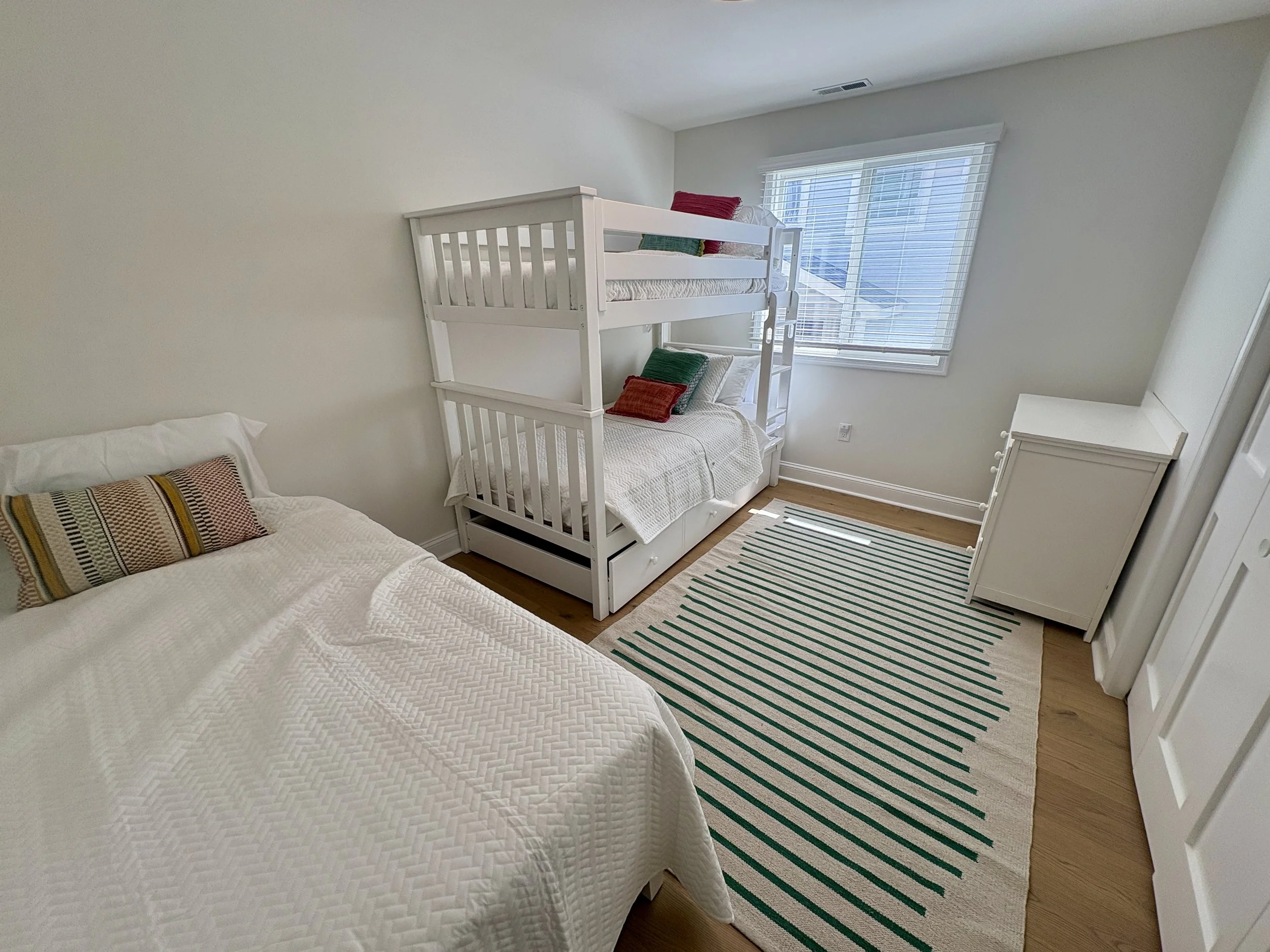 Bunk room featuring twin bed, twin bunks with pull-out trundle (4 indvidual beds)