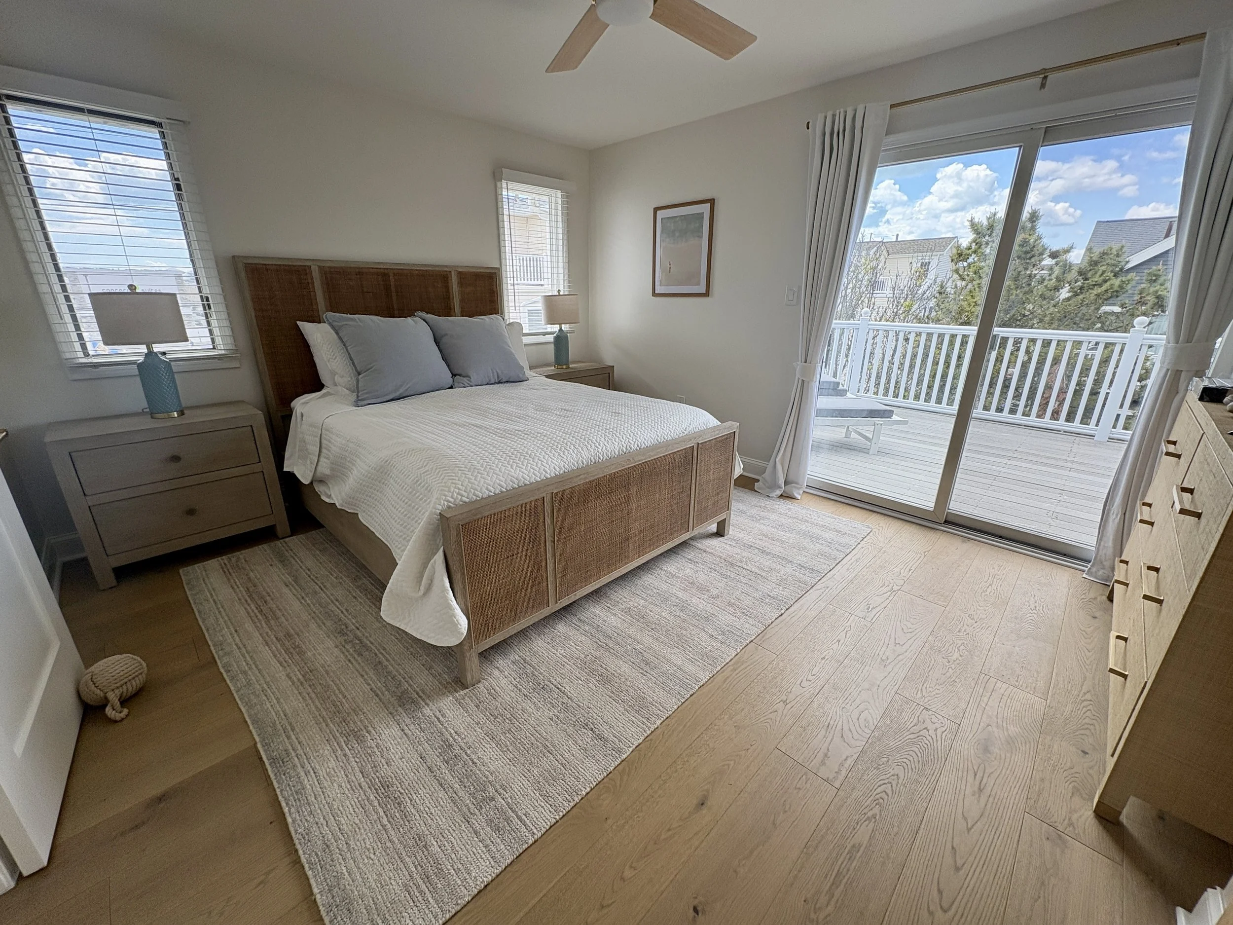 Master Bedroom with queen bed, luxurious ensuite bath and large private deck with lounge chairs for relaxing in the afternoon sun