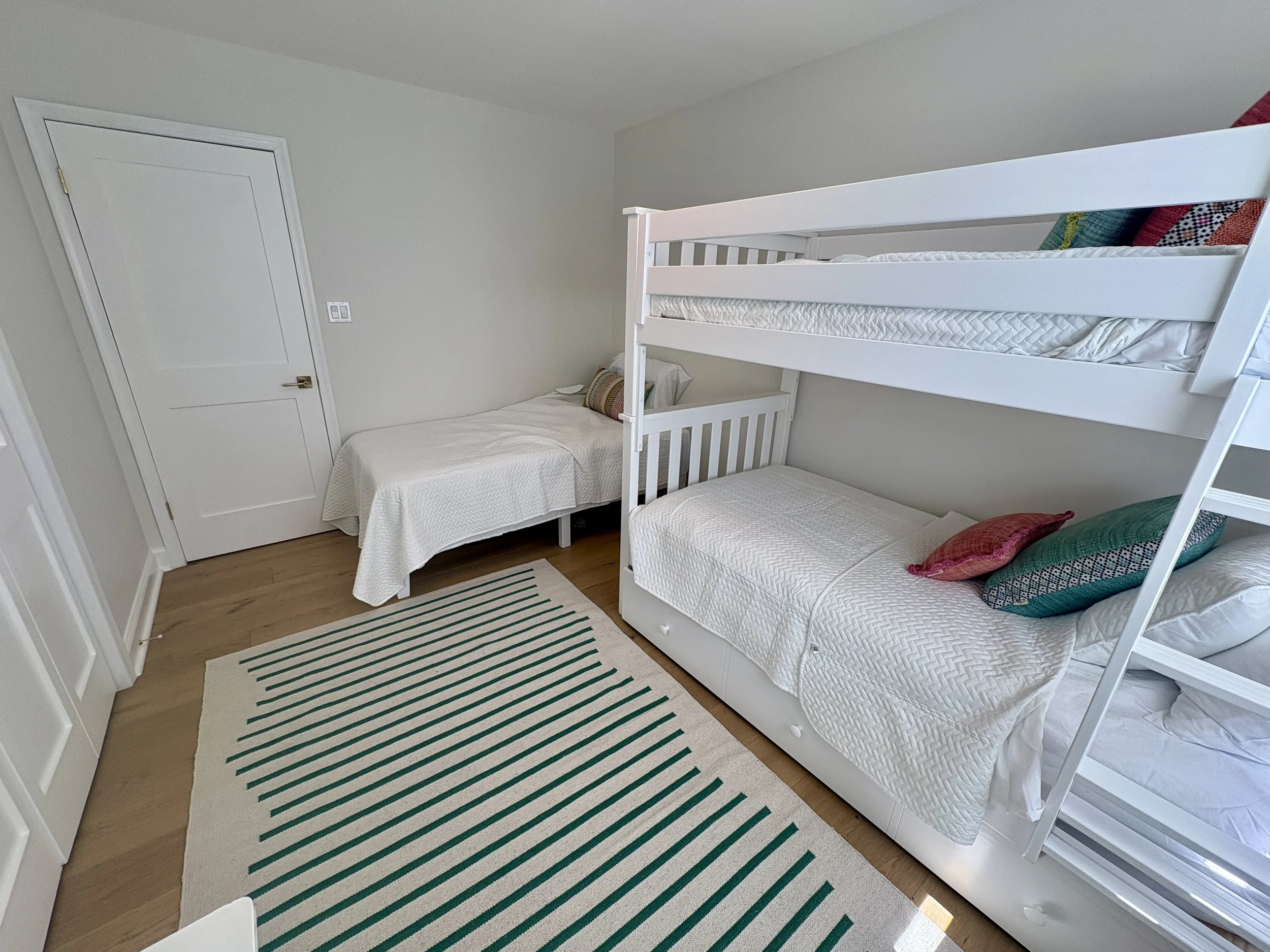 Bunk room featuring twin bed, twin bunks with pull-out trundle (4 distinct beds)