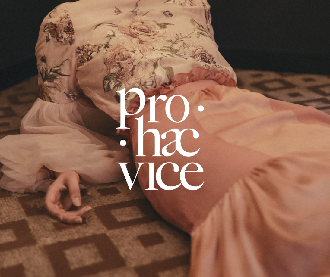 Une personne en robe rose flottante allongée sur un tapis à motifs, avec le logo 'pro.ha.vice' superposé.