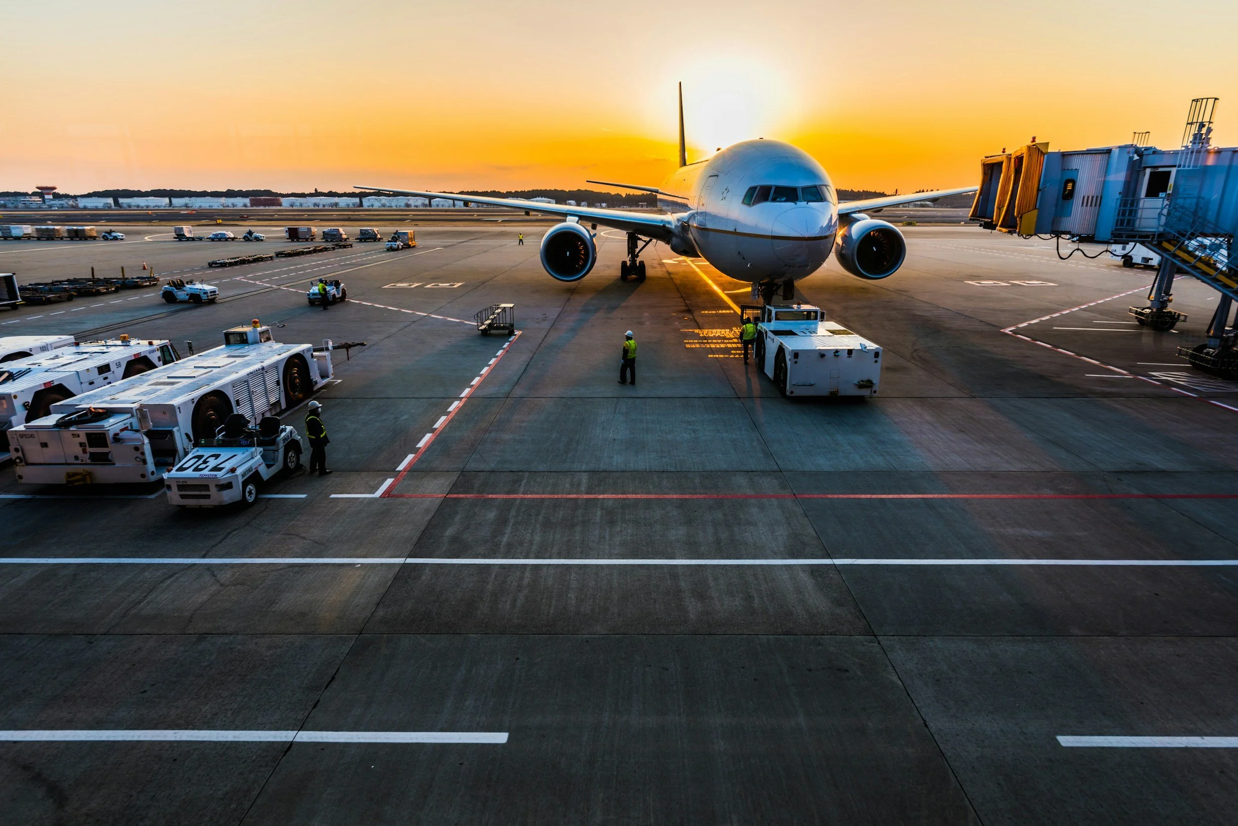 An airplane parking at an airport gate