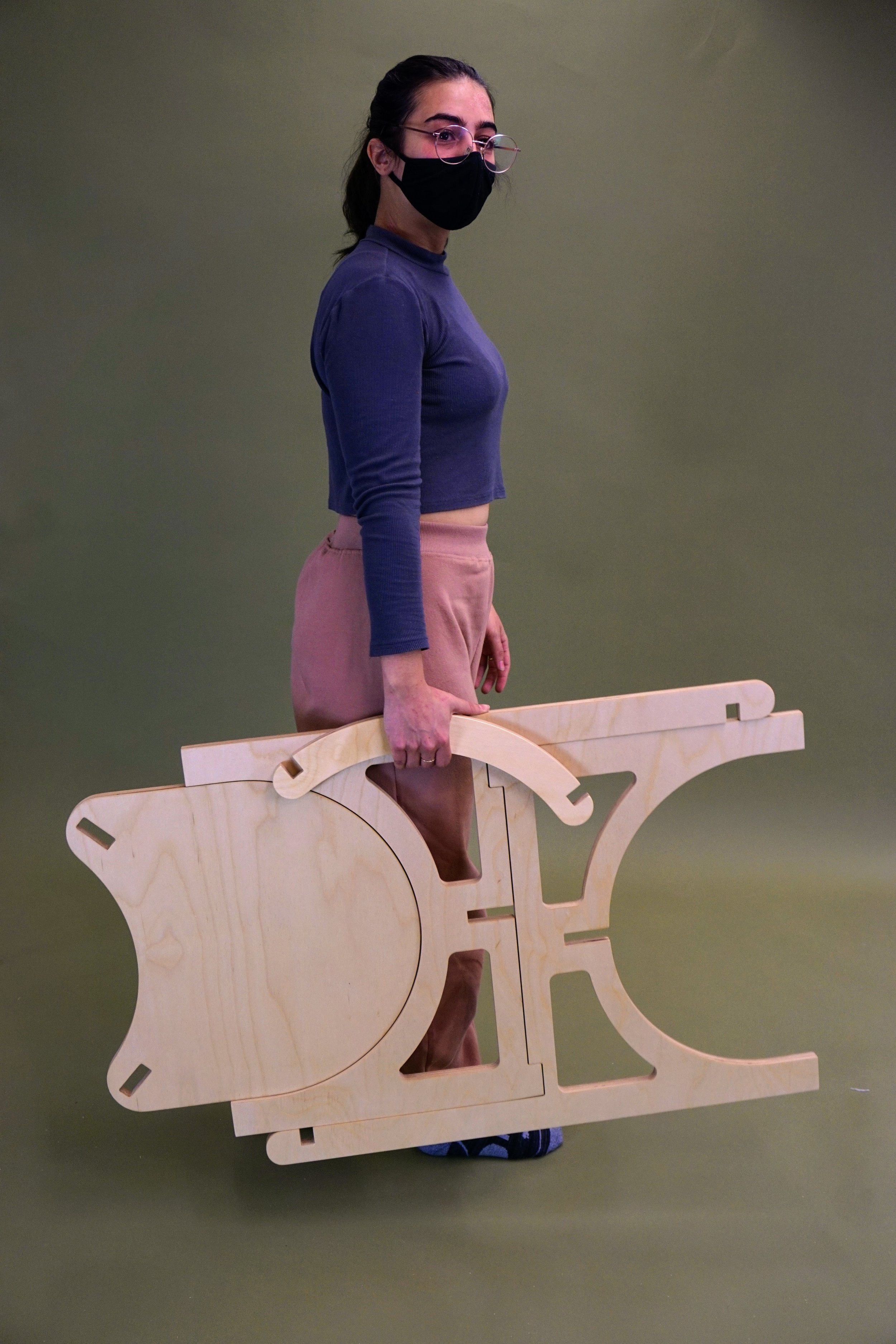 Woman standing holding flat chair