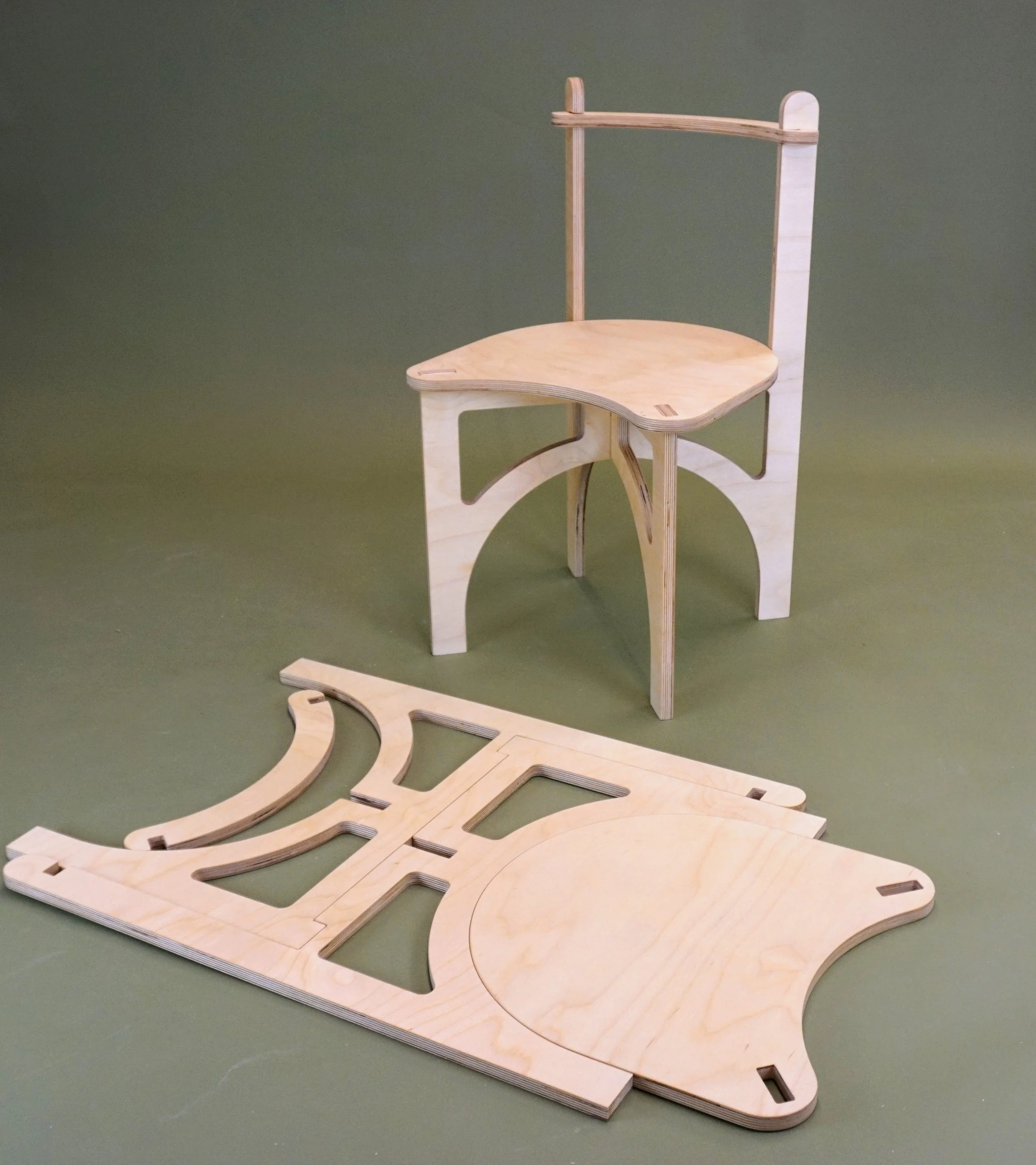 Two chairs, one assembled and one disassembled on the floor