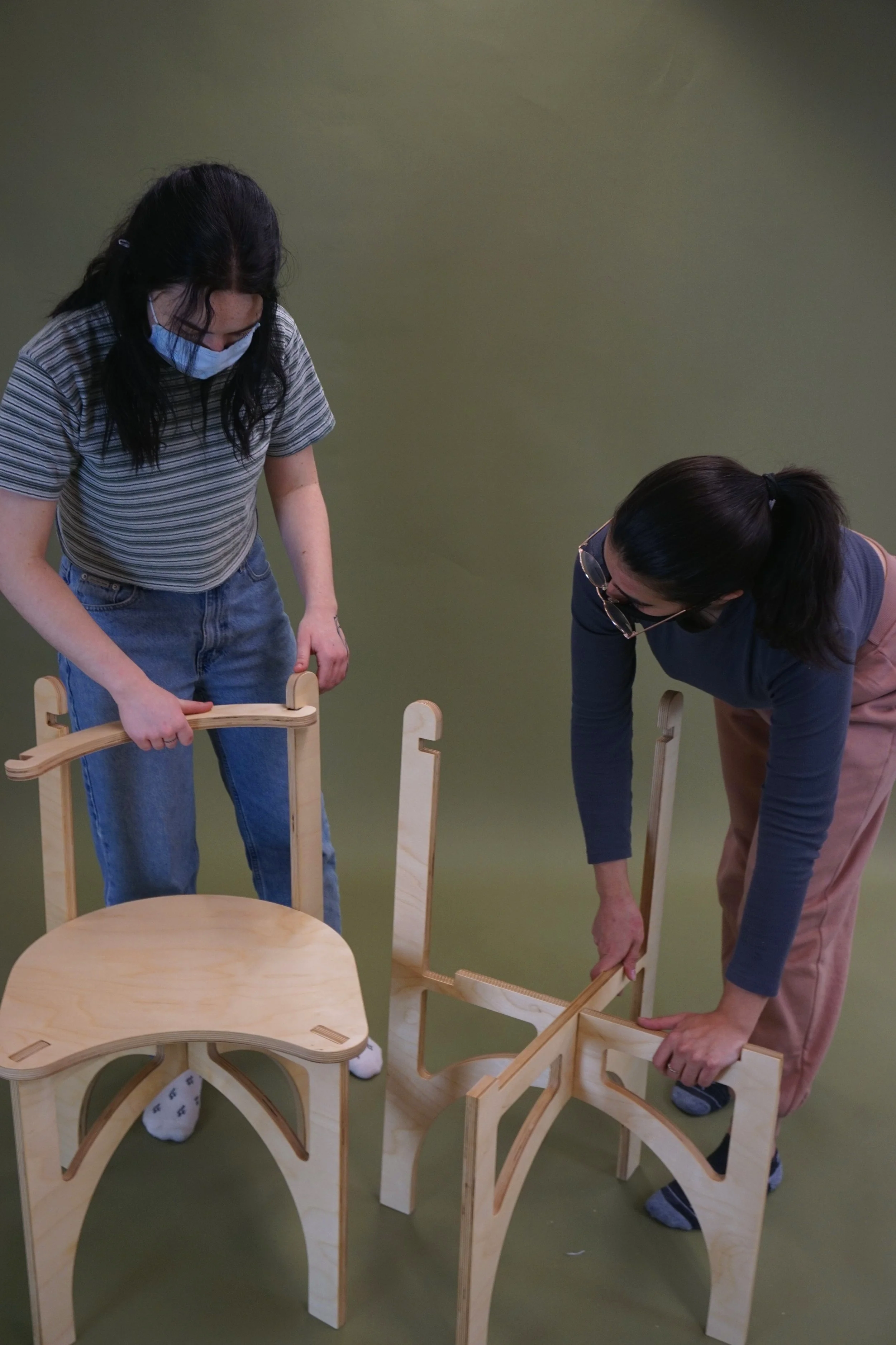Two people assembling the chairs