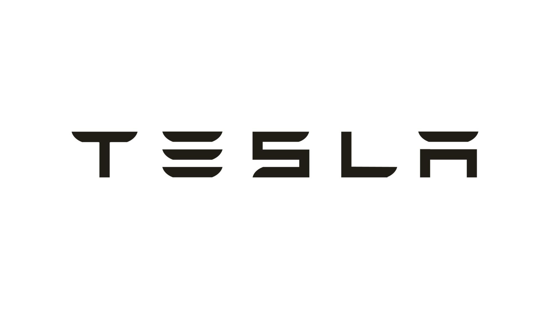 Das Bild zeigt das Tesla-Logo in schwarzer Farbe auf weißem Hintergrund.
