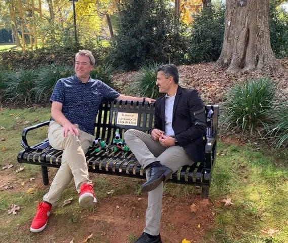 Alex and Kevin on the bench dedicated to Alex at Reinhardt University