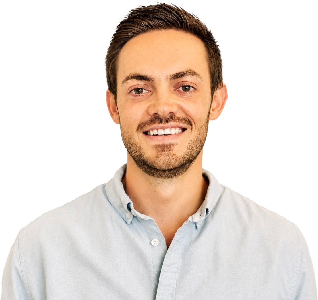 A young man with brown hair, light beard, and white shirt smiling at the camera.
