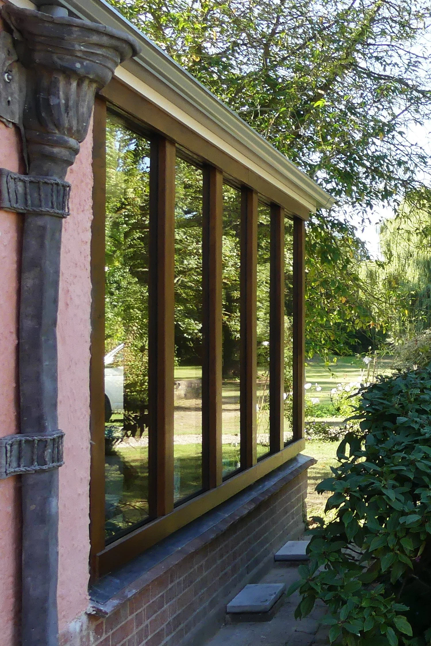 A traditional oak infill has opened up the garden room and enhanced the existing