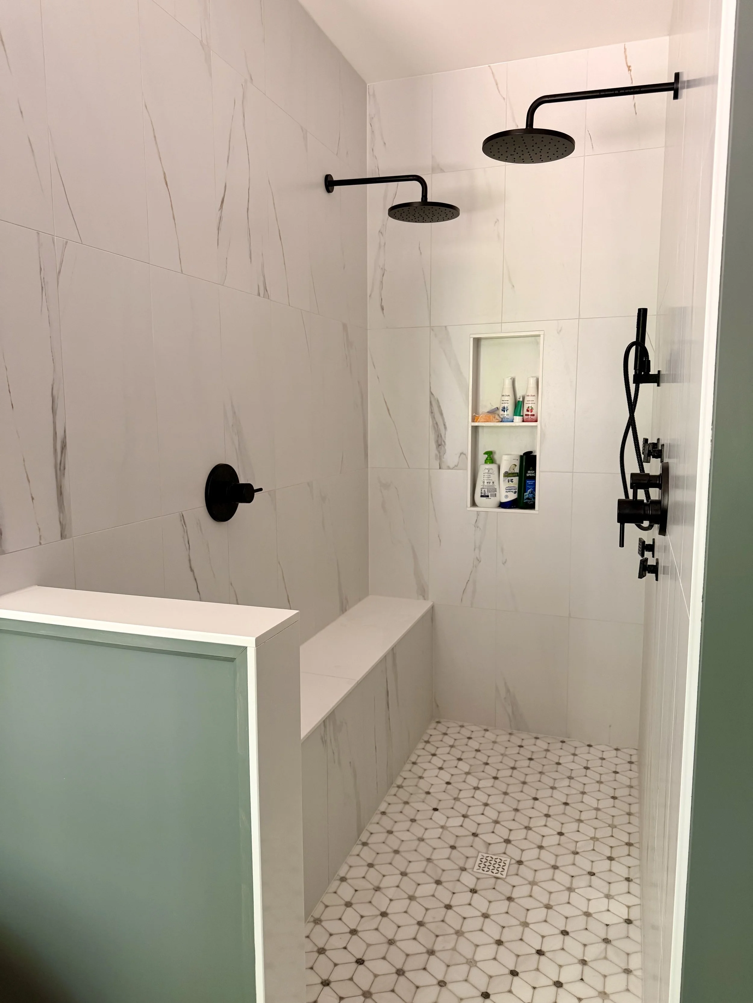 DOUBLE SHOWER WITH RAIN HEADS, BODY SPRAYS, AND HANDHELDS. 