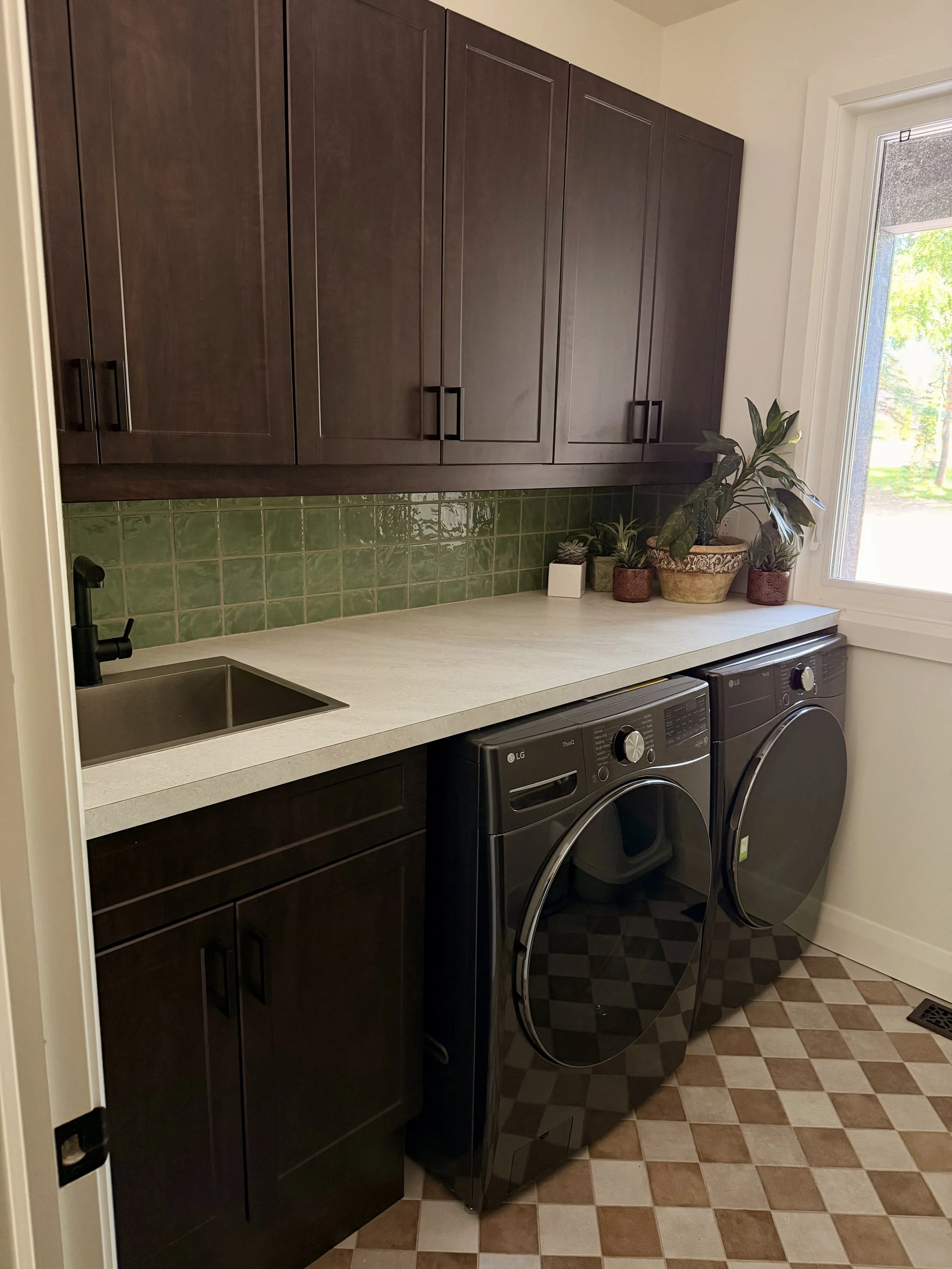 LAUNDRY ROOM COMPLETE WITH LAUNDRY SINK, WASHER, AND DRYER. 
