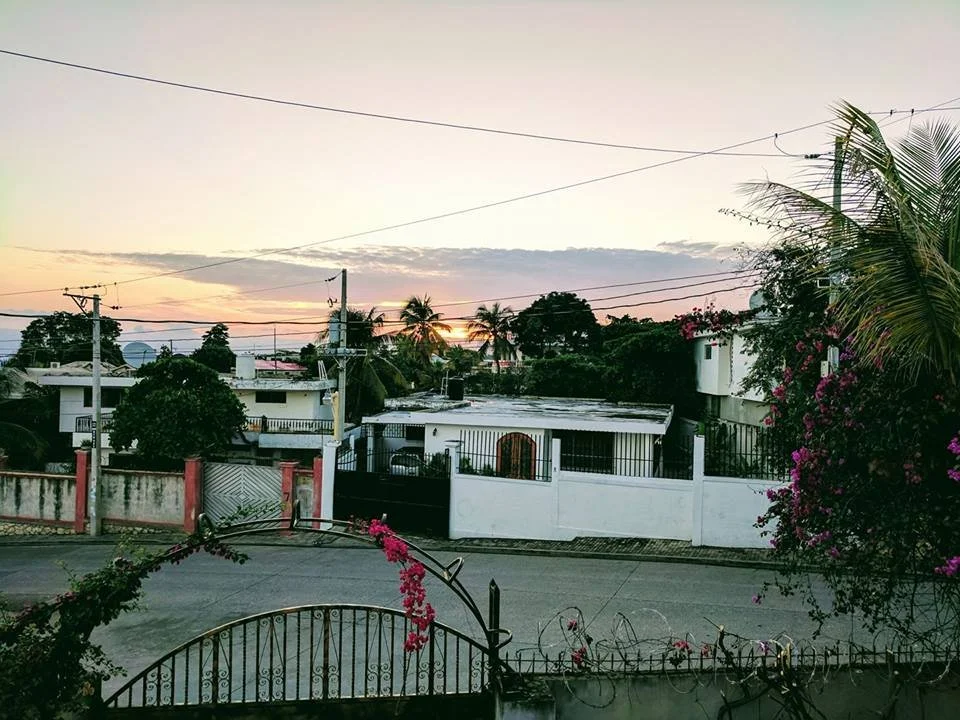 The sun rises over households in Haiti.