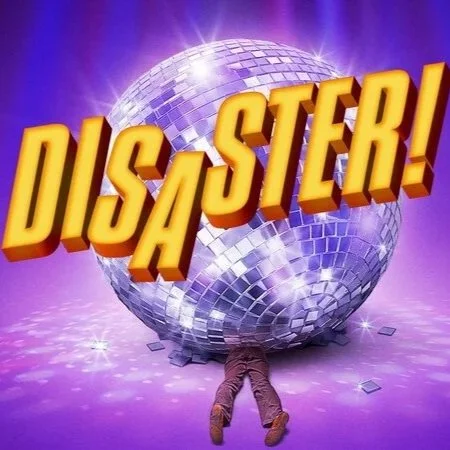 A person on the floor with their head and arms beneath a large, shiny disco ball, with the word "DISATER!" in bold yellow letters across the disco ball and background with purple and blue lighting effects.