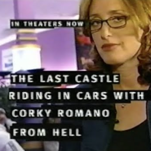 A woman, comedian Judy Gold, with glasses and shoulder-length hair smiling, with a purple background and text promoting a film titled 'The Last Castle' about riding in cars with Corky Romano from Hell.