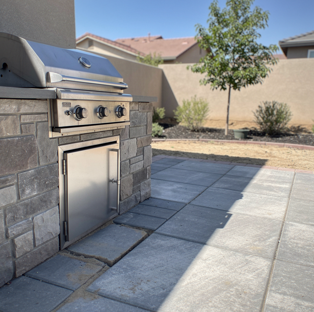 Prefab and built-in BBQ islands side by side on patio