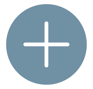 Close-up of a blue circular button with a black plus (+) sign in the center.