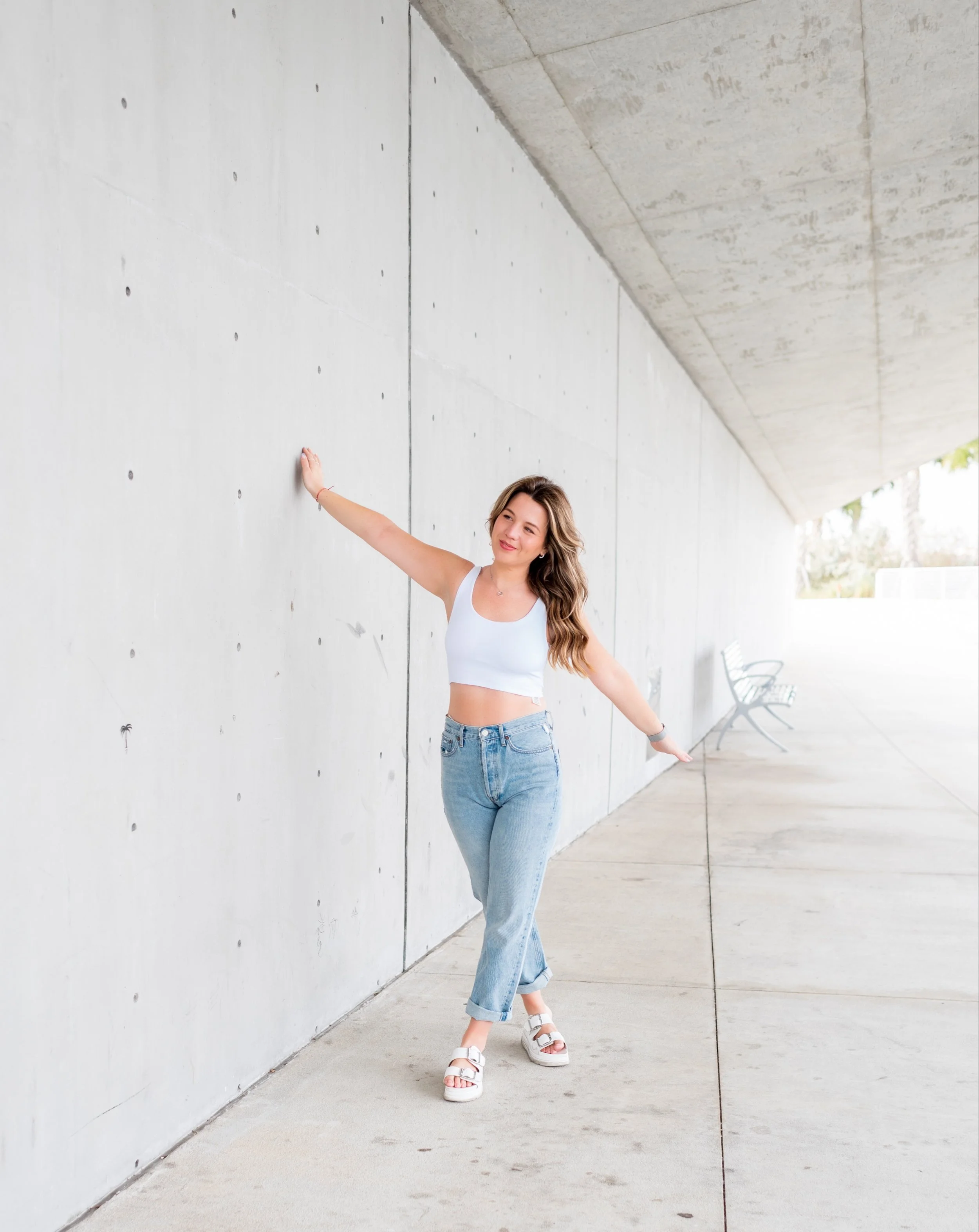 Woman walking along an outdoor wall