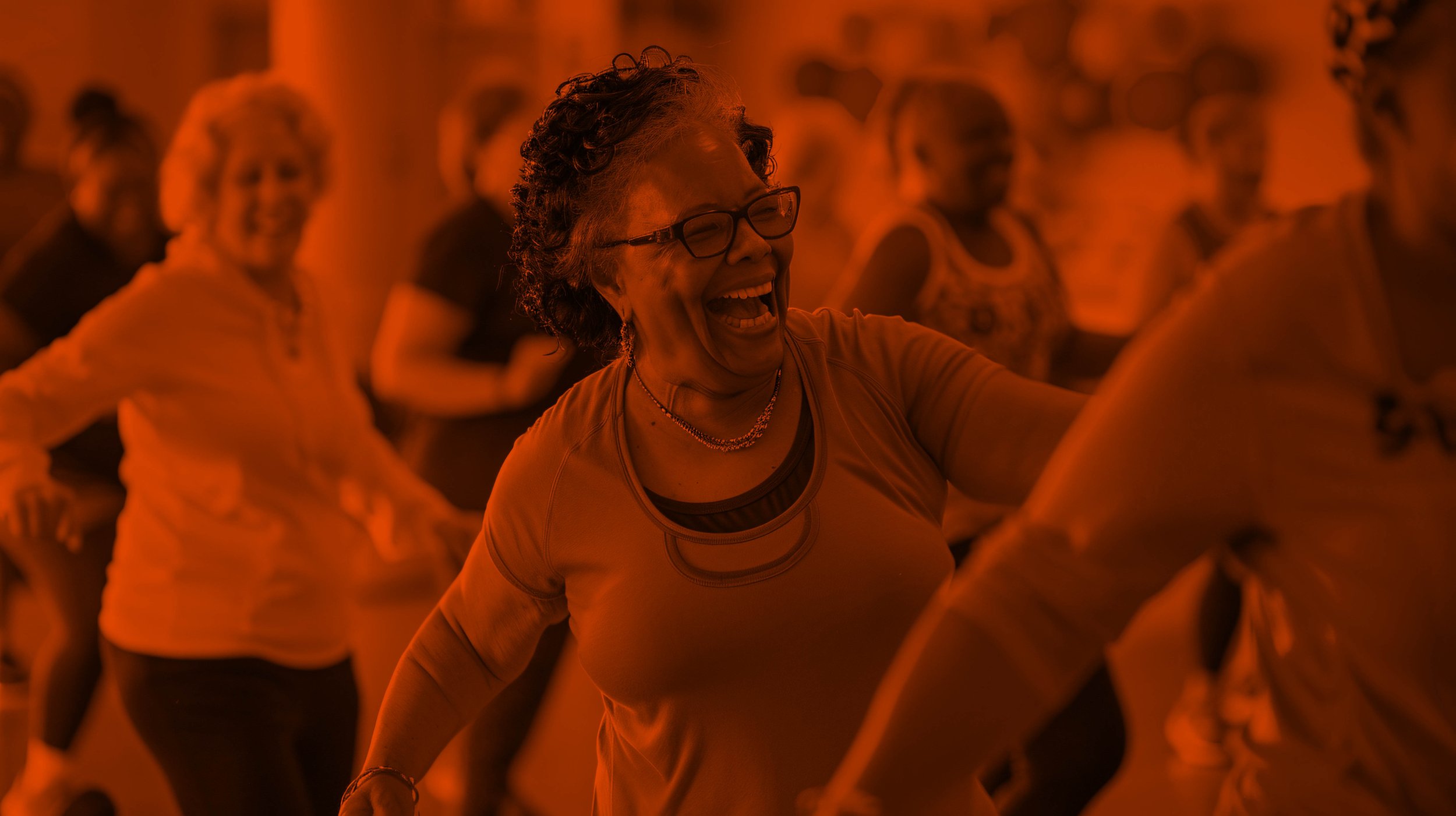 A group of women dancing and celebrating together in a lively event.
