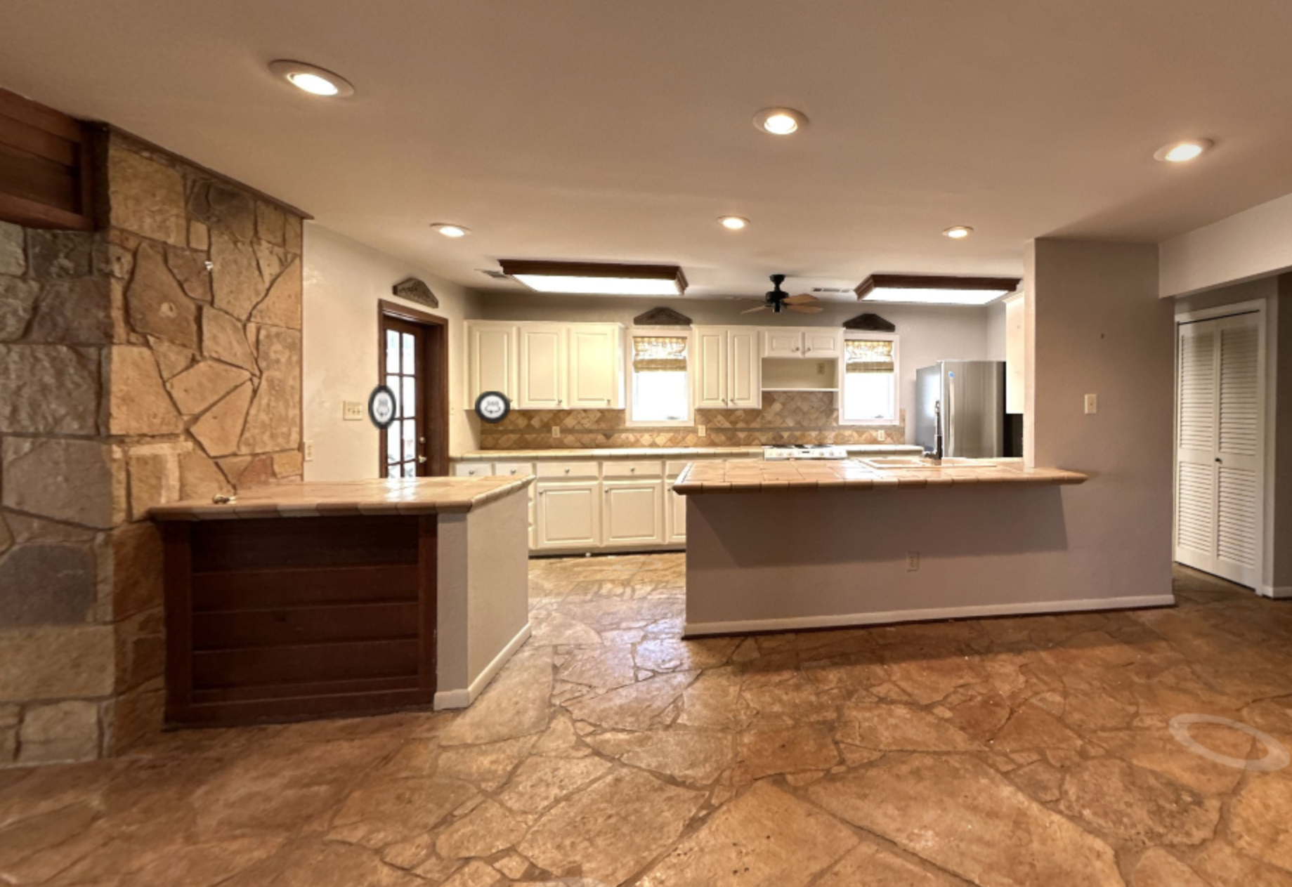 Before photo of the Lake McQueeney Residence kitchen and bar area showing the original layout prior to interior planning and renovation by Burleson Architecture.