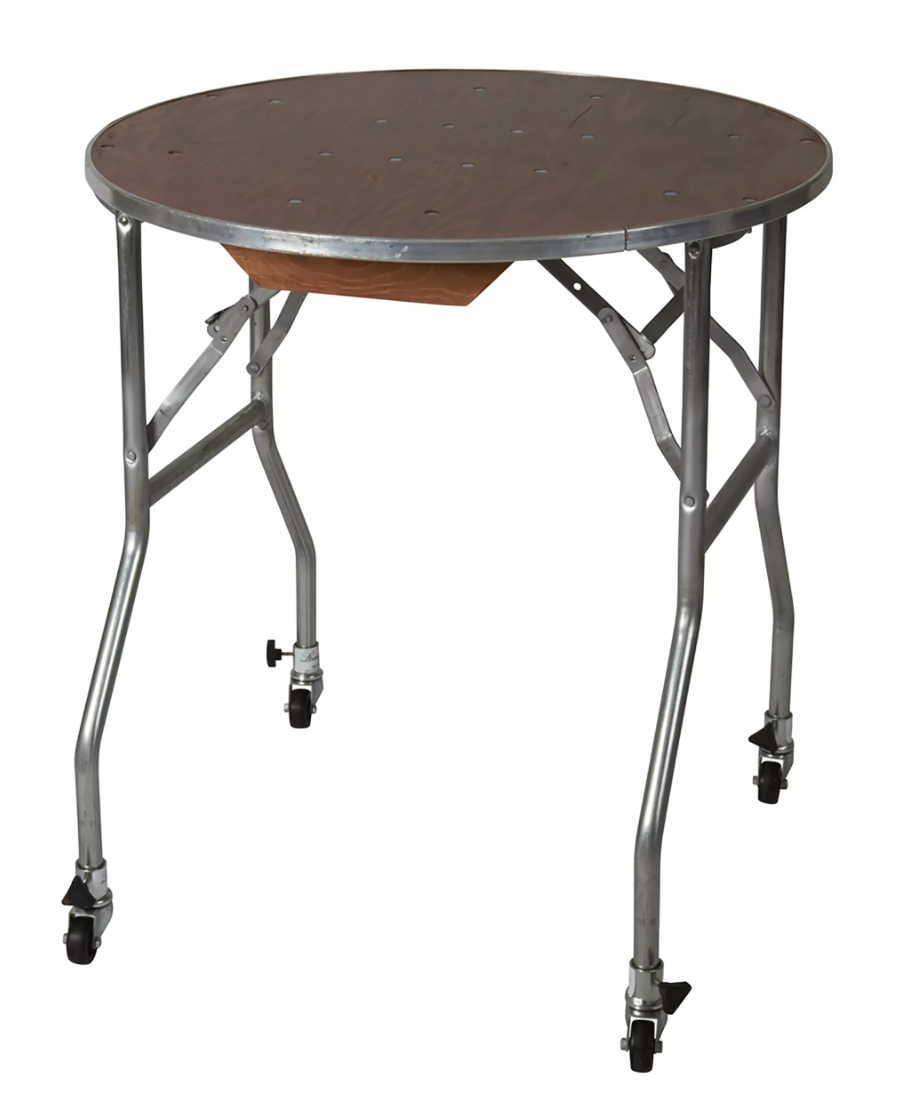 A round medical or industrial stand with a metal top and metal legs on casters.