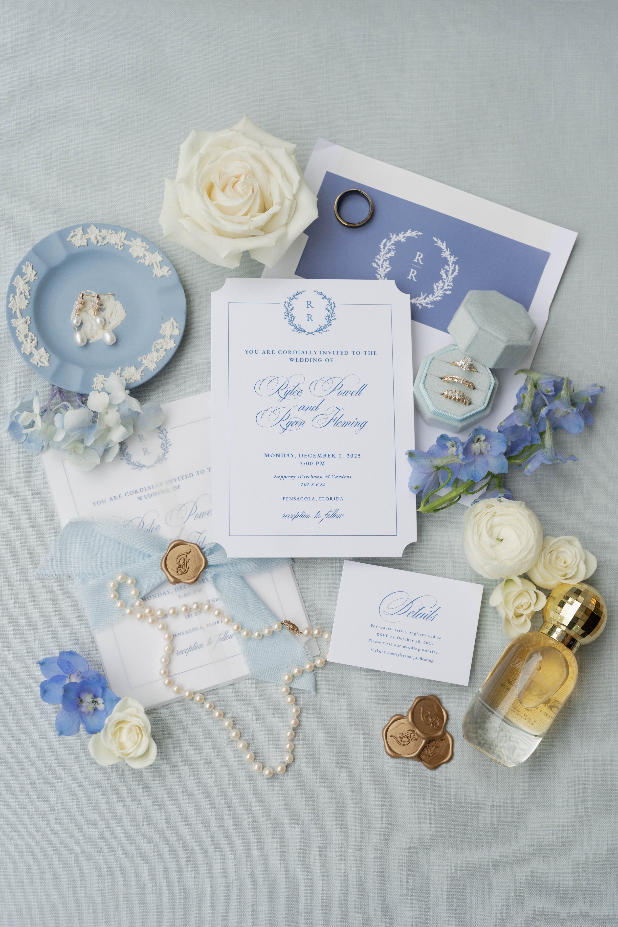 Wedding invitation suite with complimentary accessories and decorations, including ring box, jewelry, flowers, perfume, and a ring.