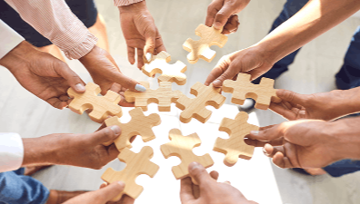 Group of people putting together puzzle pieces