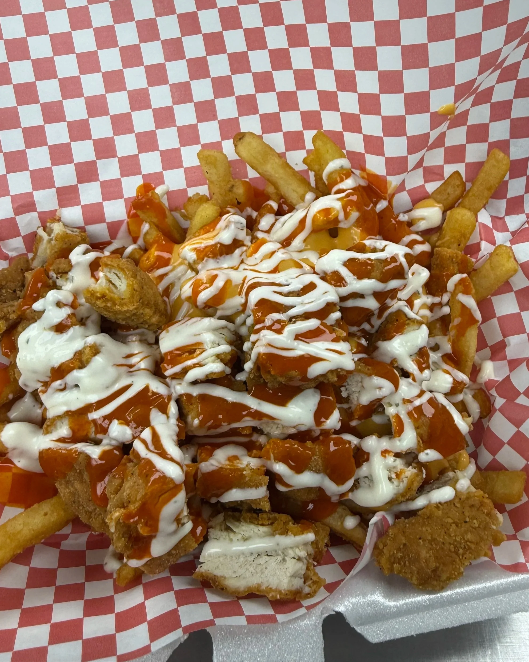 AJ’s Restaurant & Deli Kenosha loaded chicken fries with crispy fries, chicken, cheese, and toppings.