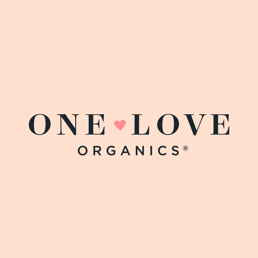Logo with the text 'ONE LOVE ORGANICS' on a pale pink background, featuring a small pink heart between 'ONE' and 'LOVE'.