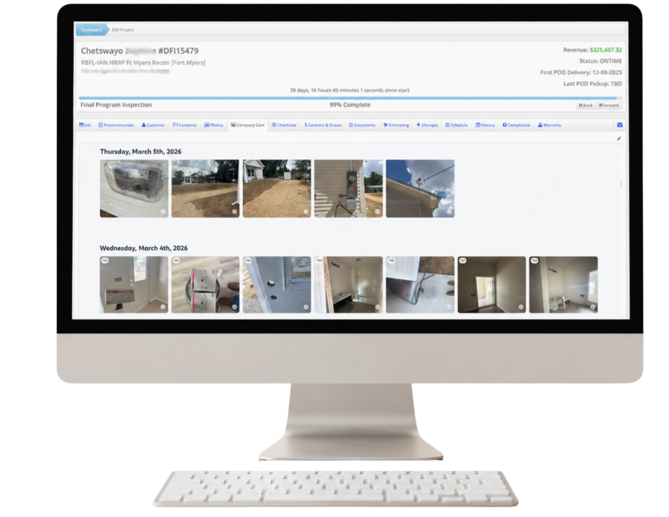 Computer monitor displaying a project management dashboard with photos and inspection status details for a construction or home improvement project.