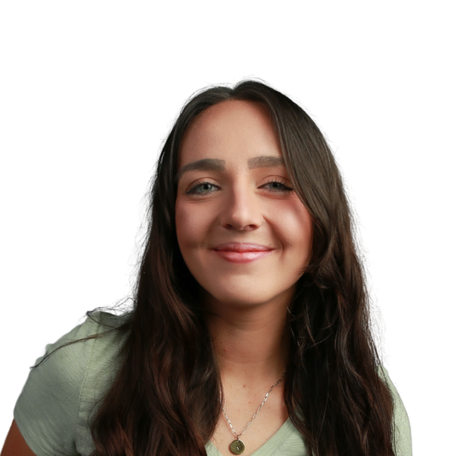 A young woman with long dark hair and a light green shirt smiling.